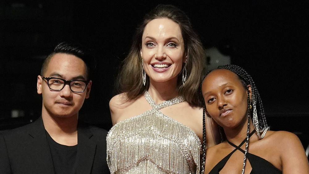 Angelina Jolie posing with kids Maddox and Zahara on the red carpet