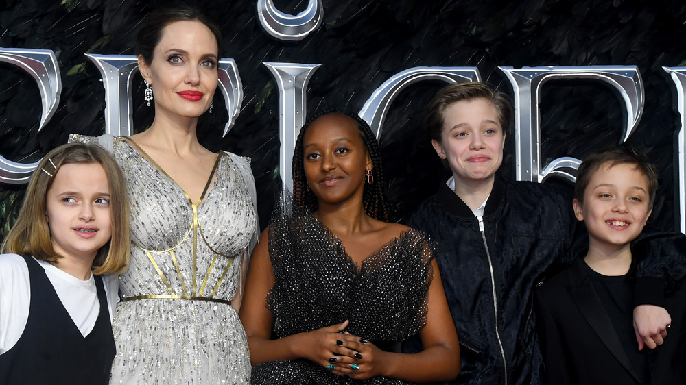 Angelina Jolie posing with four of her children on the red carpet