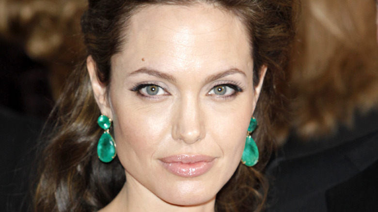 Angelina Jolie wearing green earrings