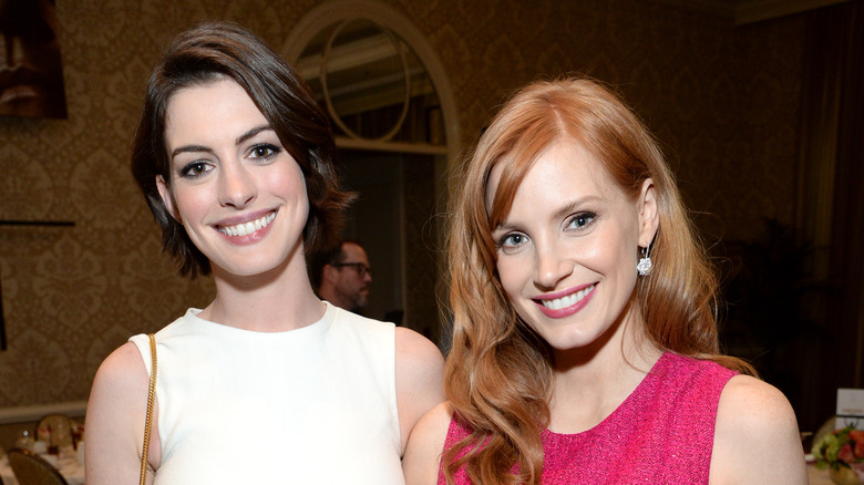 Anne Hathaway and Jessica Chastain pose in white and pink dresses