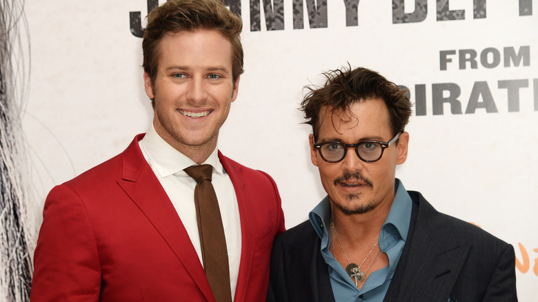 Armie Hammer smiling with Johnny Depp