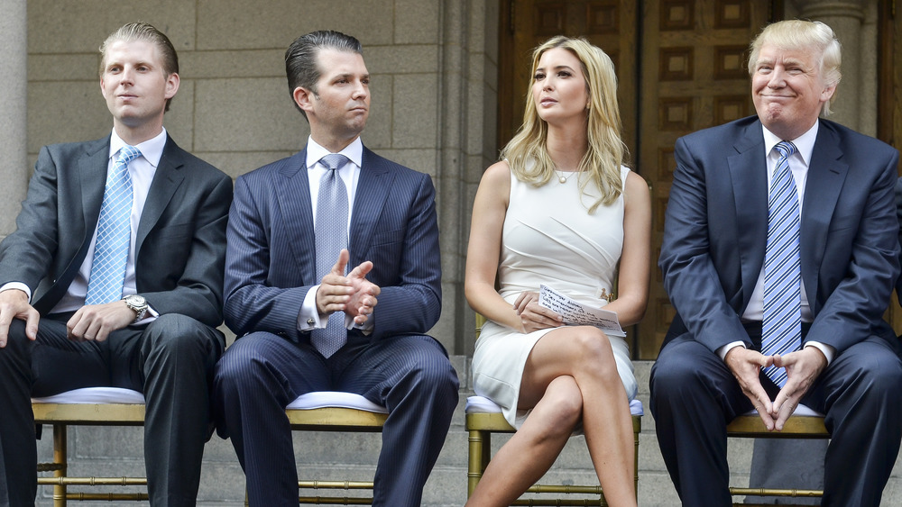 Donald Trump Jr. and his siblings, and Donald Trump seated