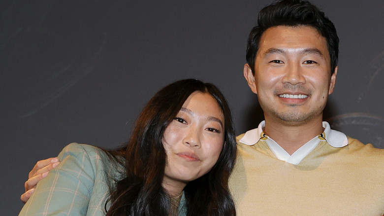 Simu Liu with arm around Awkwafina 