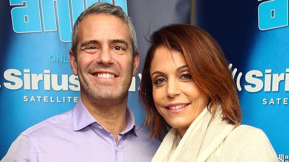 Andy Cohen and Bethenny Frankel smiling while posing at a SIRIUSXM event