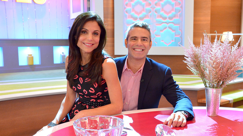 Bethenny Frankel sits on Andy Cohen's lap