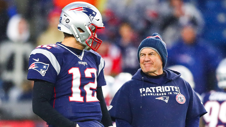 Tom Brady and Bill Belichick share a moment on the field