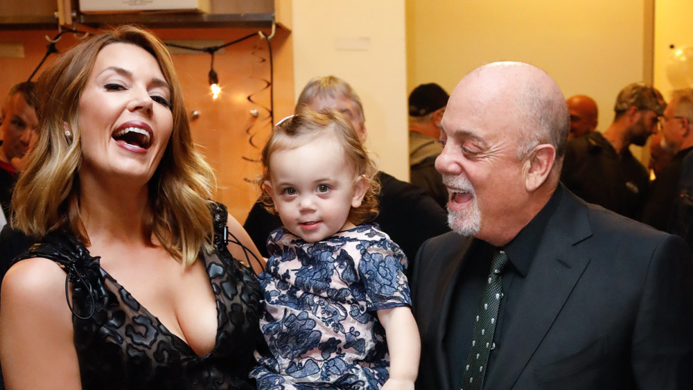 Alexis, Remy Anne and Billy Joel all laughing and smiling