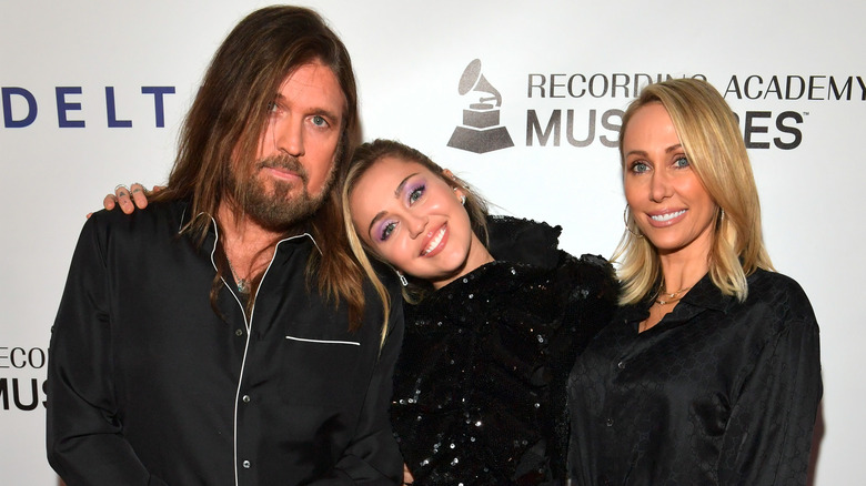 Billy Ray, Miley, and Tish Cyrus smling