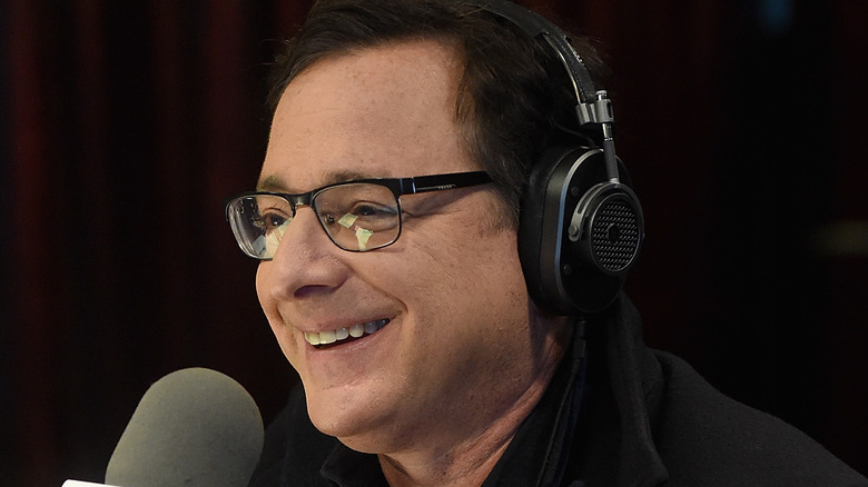 Bob Saget speaks into radio mic