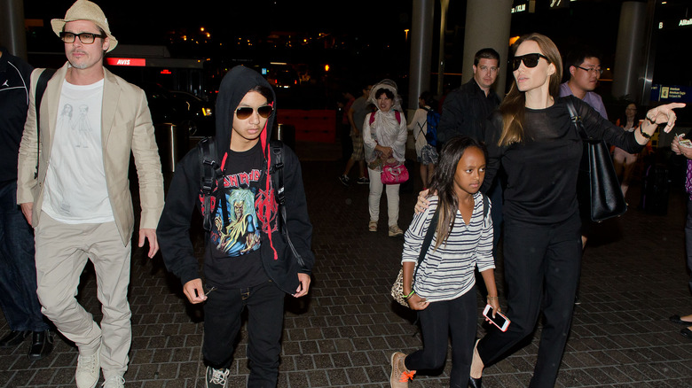 Brad Pitt, Maddox Jolie-Pitt, Zahara Jolie-Pitt and Angelina Jolie walking at LAX