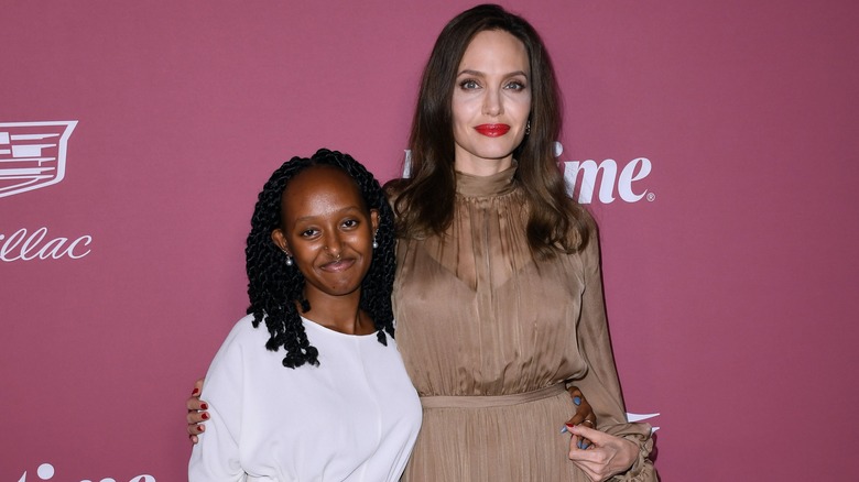 Zahara Jolie-Pitt and Angelina Jolie smiling on a red carpet