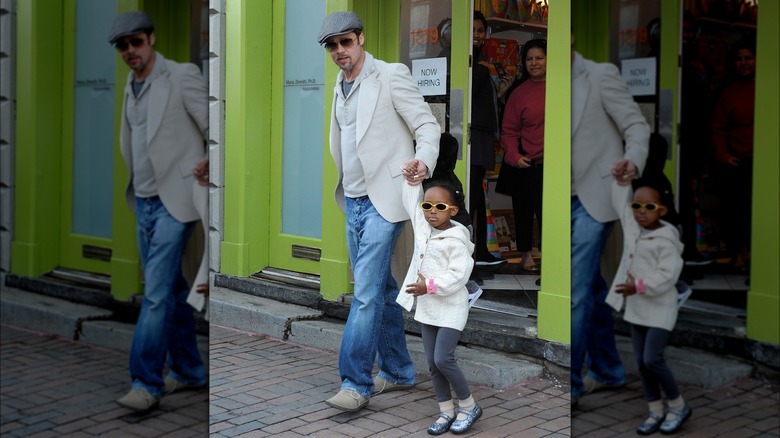 Brad Pitt holding Zahara Marley Jolie's hand in 2009