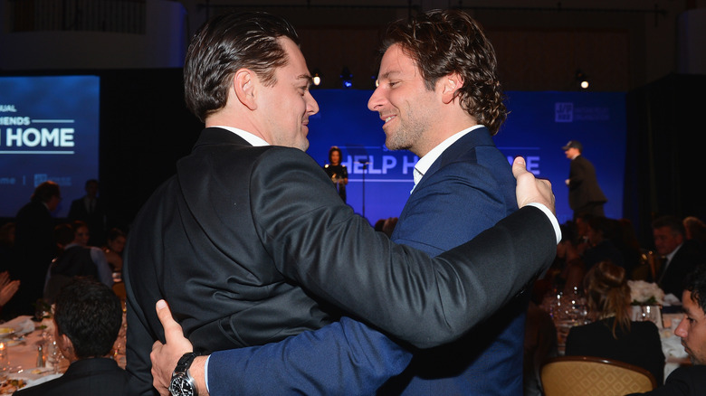 Leonardo DiCaprio and Bradley Cooper hugging