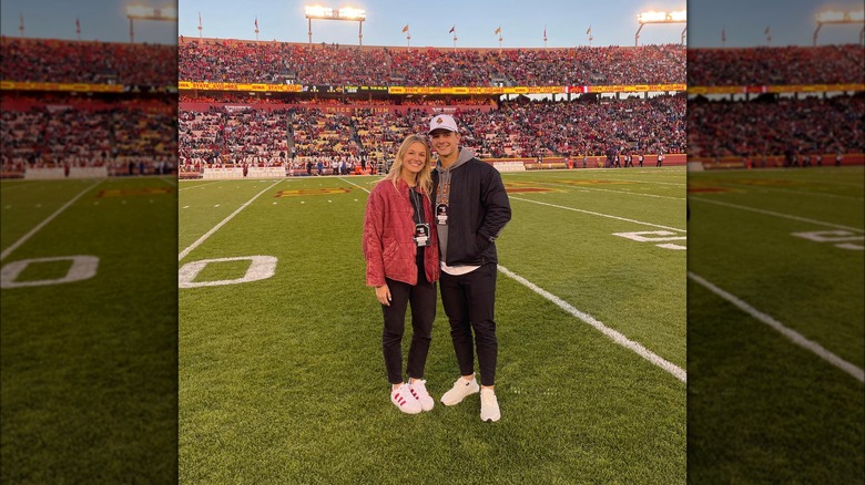 Brock Purdy and Jenna Brandt stand on football field