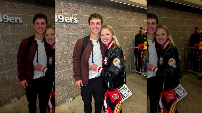 Brock Purdy and Jenna Brandt embrace near brick wall