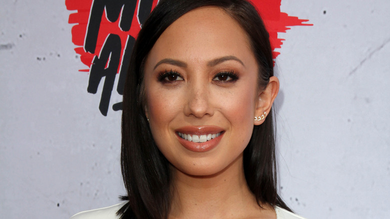 Cheryl Burke smiling at a red carpet