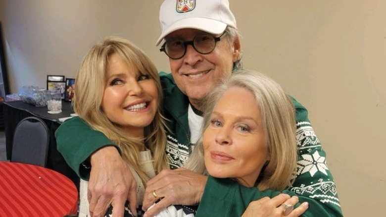 Christie Brinkley, Chevy Chase, and Beverly D'Angelo hugging