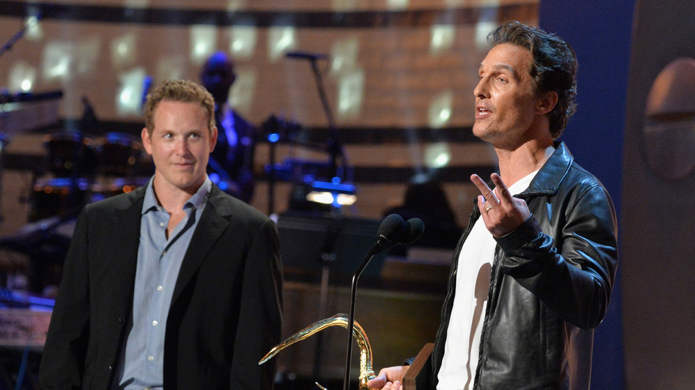 Cole Hauser and Matthew McConaughey onstage during an award.