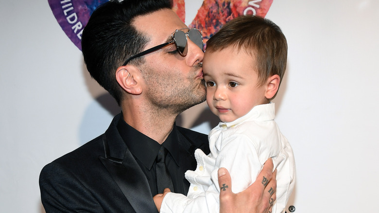 Criss Angel holding son Johnny Crisstopher