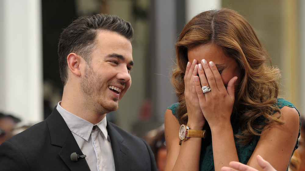 Kevin Jonas smiling, Danielle Jonas shocked