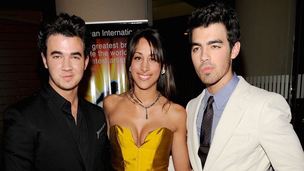 Kevin Jonas, Danielle Jonas, and Joe Jonas posing