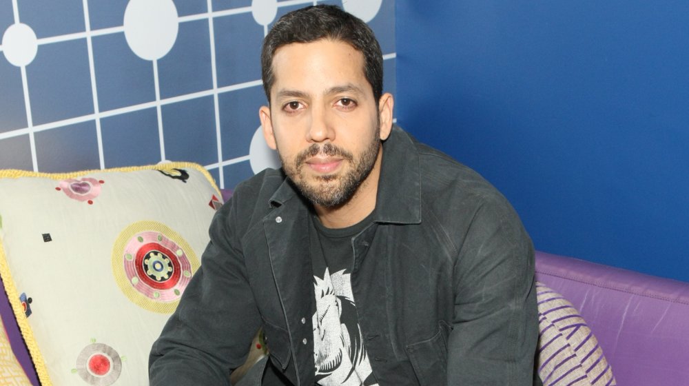 David Blaine sitting down on purple sofa