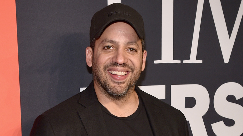 David Blaine smiling with a baseball hat on
