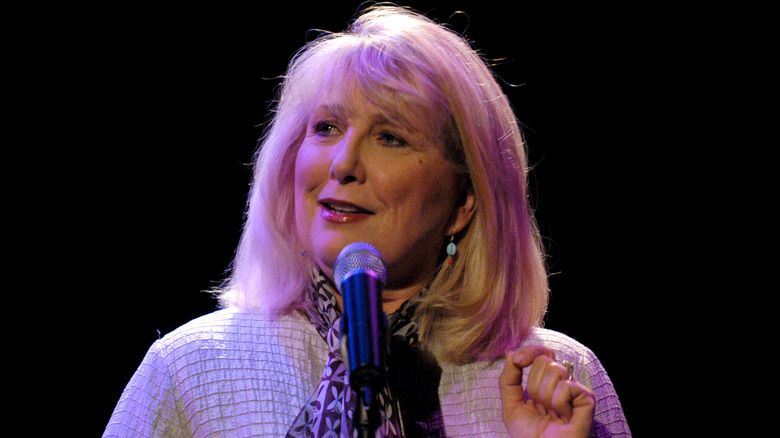 Teri Garr speaking into a mic