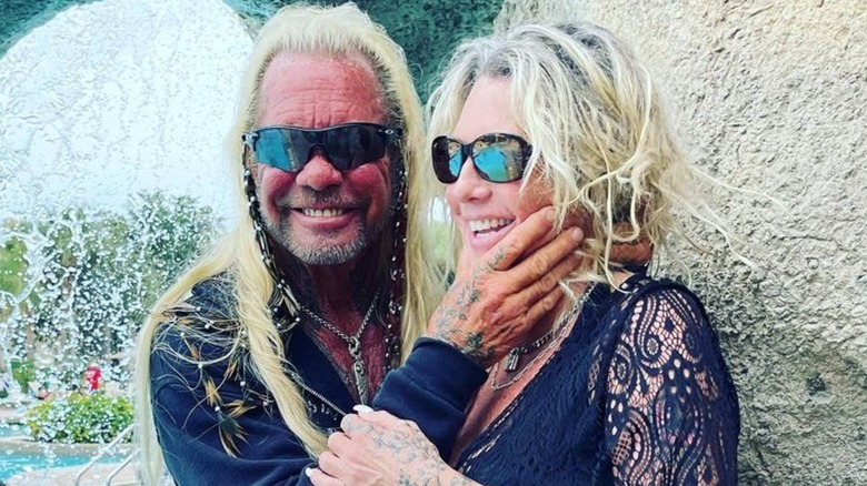 Dog the Bounty Hunter and Francie Frane smiling and wearing sunglasses