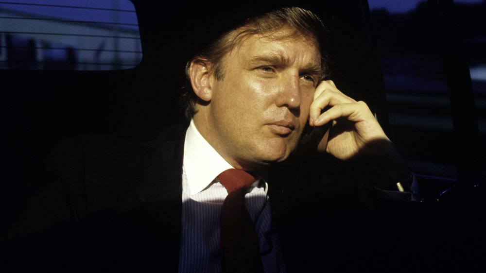 Donald Trump talking on the phone in a limo in 1987