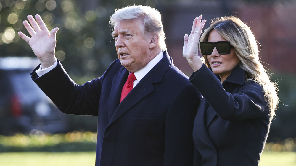 Donald and Melania Trump walk on the South Lawn in December 2020