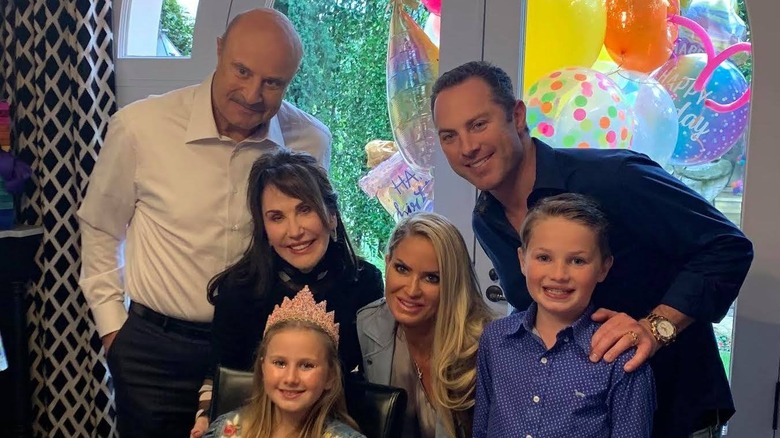 Dr. Phil and Robin McGraw posing with grandchildren