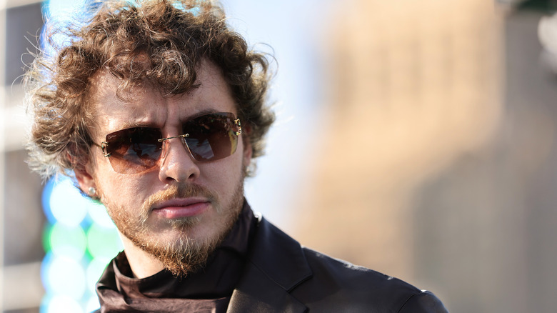 Jack Harlow with sunglasses and a scarf