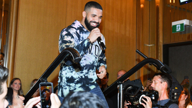 Drake holding a microphone