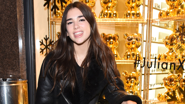 Dua Lipa smiling, tongue out