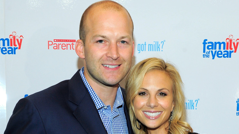 Elisabeth and Tim Hasselbeck smiling on red carpet