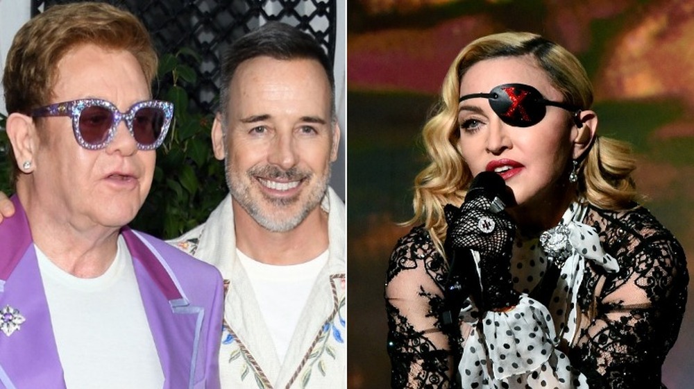 Elton John and David Furnish posing, Madonna singing