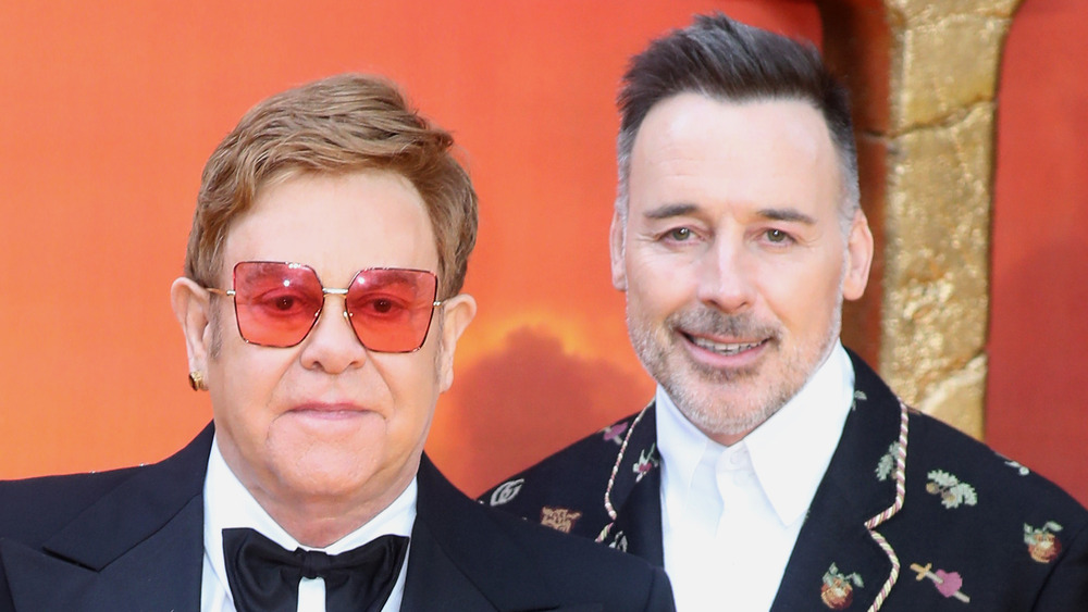 Elton John mad and David Furnish adorned suit