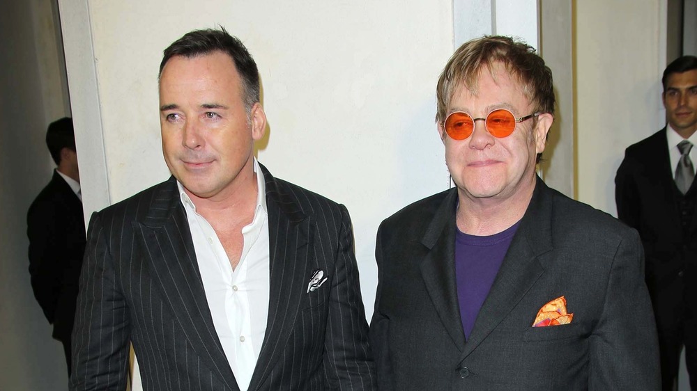 David Furnish and Elton John smirking