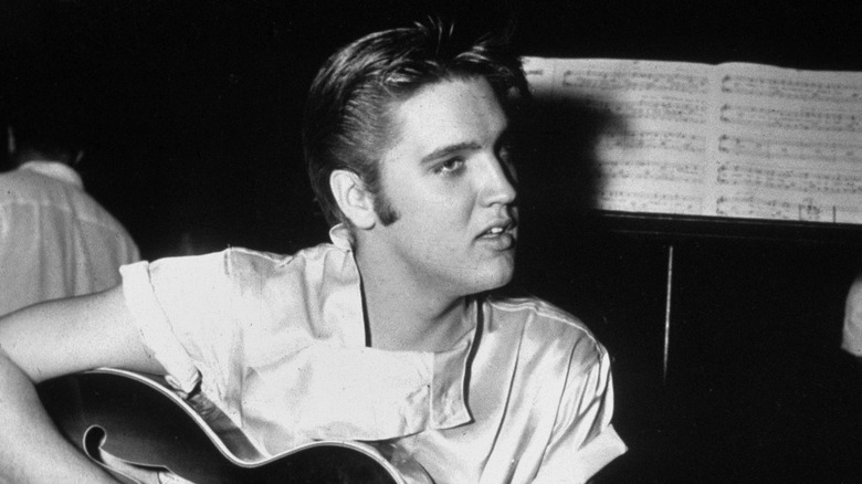 Elvis Presley playing guitar