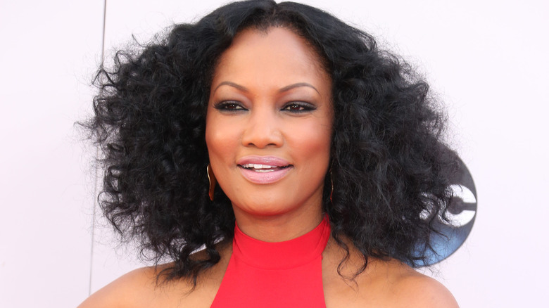 Garcelle Beauvais smiles on red carpet