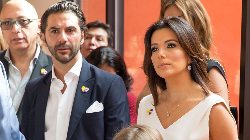 Jose Baston and Eva Longoria in a crowd, watching something