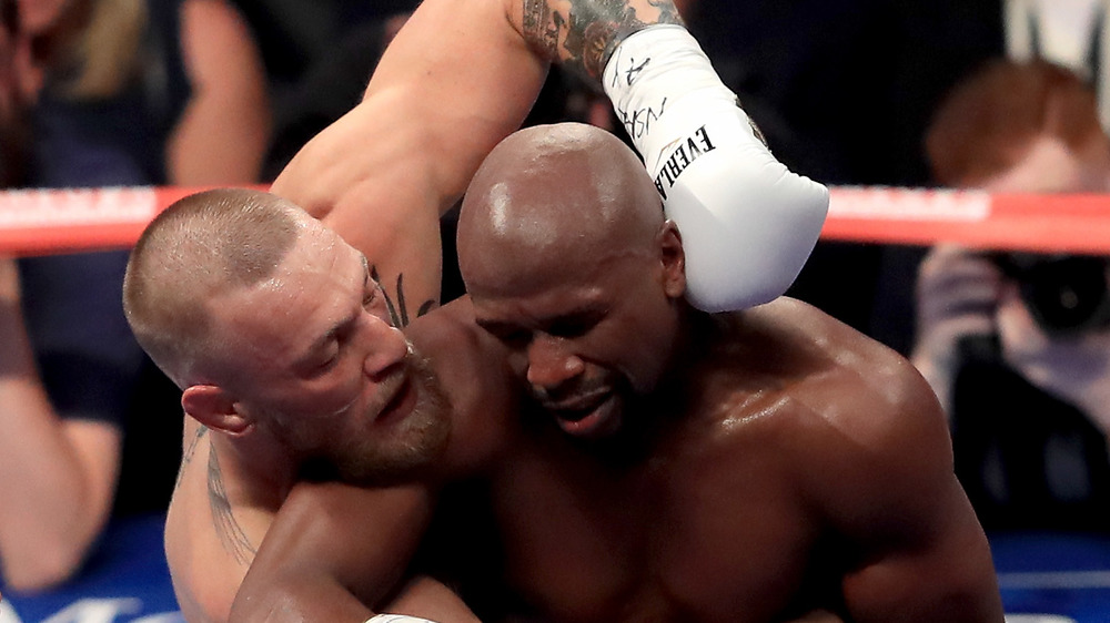 Conor McGregor and Floyd Mayweather in middle of a boxing match