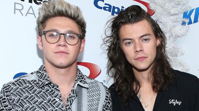 Niall Horan and Harry Styles posing at an event