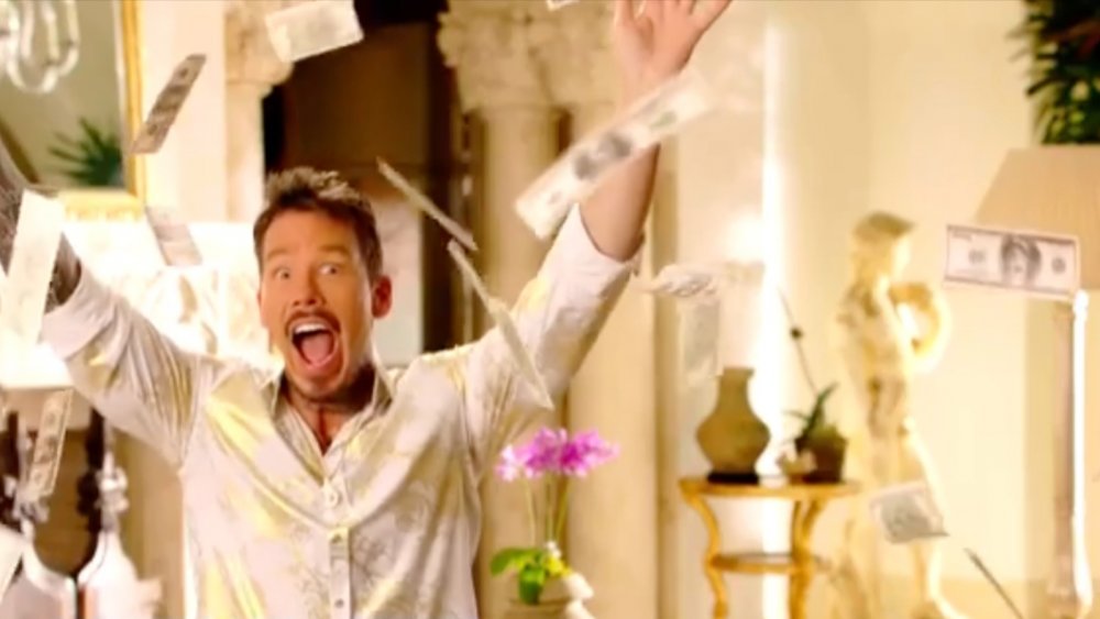 David Bromstad surrounded by cash in a My Lottery Dream Home promo