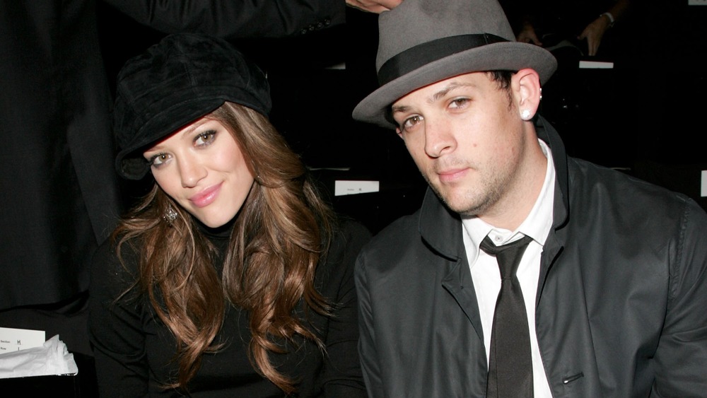 Hilary Duff and Joel Madden sitting together