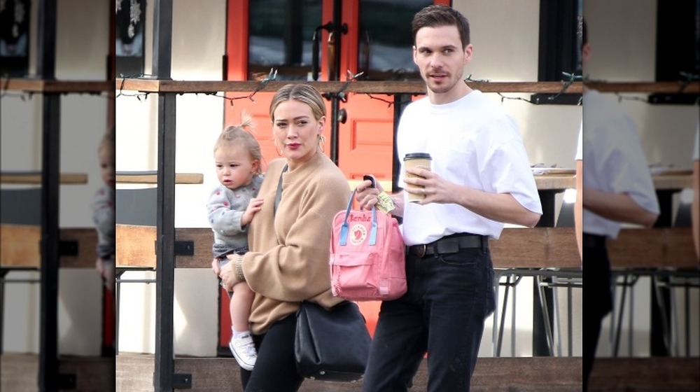 Hilary Duff, Matthew Koma, and their daughter walking outside