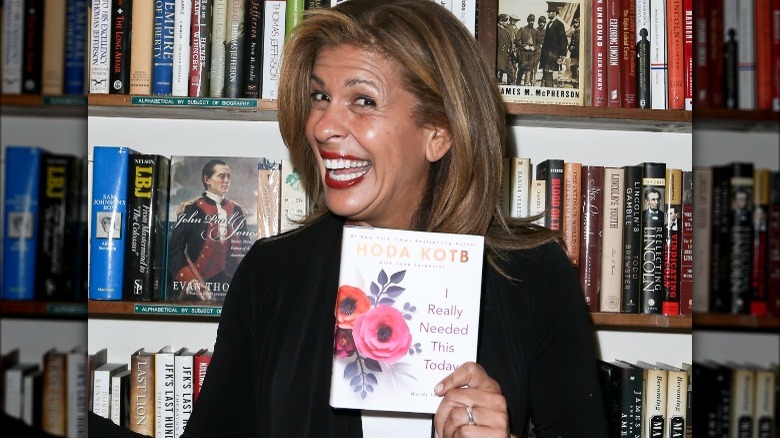 Hoda Kotb holding up book