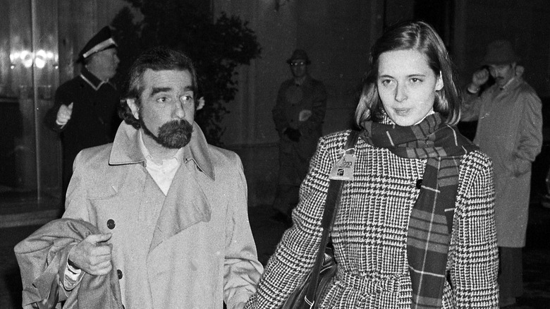 Martin Scorsese and Isabella Rossellini holding hands in the street