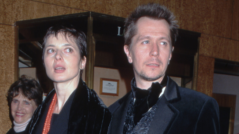 Gary Oldman and Isabella Rossellini in a lobby